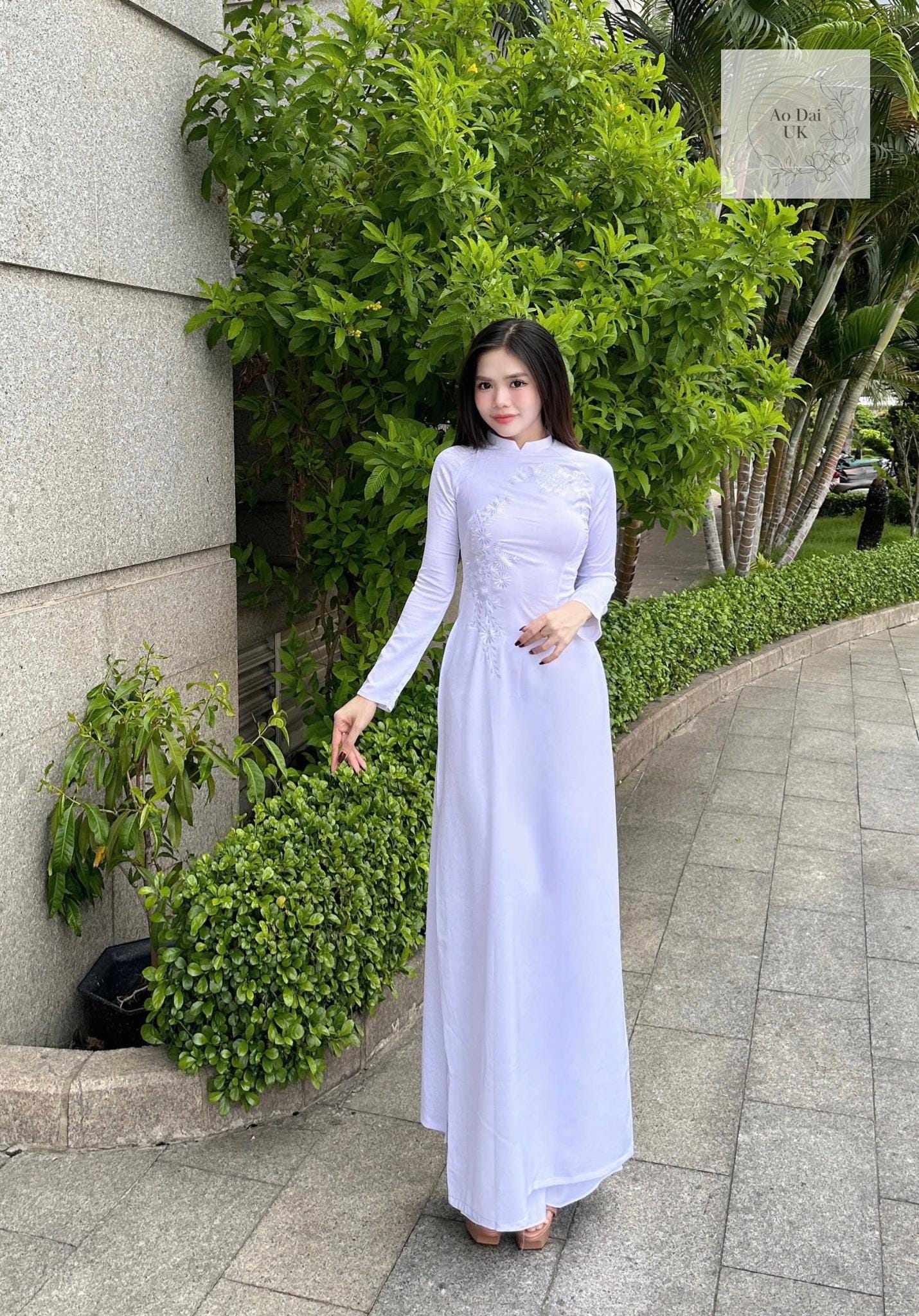 Traditional white ao dai with floral embroidery